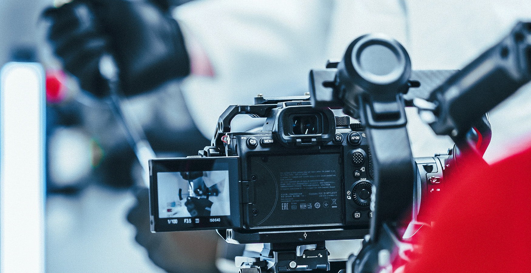 Striking image of a videographer filming in a lab using a Sony A7SIII on a gimbal, in slog 3 colour profile