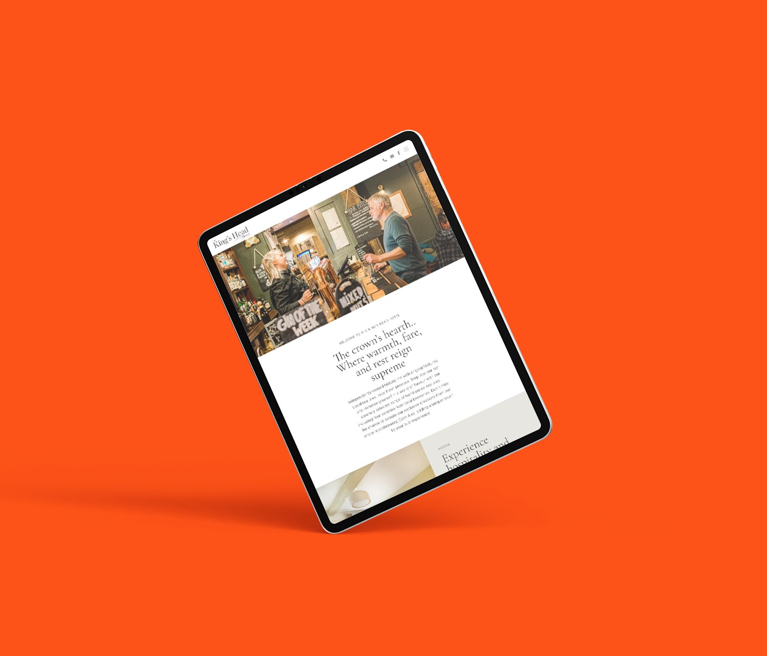 Tablet on its side, on an orange background with a website displayed on it.